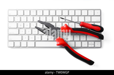 Modern wireless keyboard, pliers and screwdriver on white background Stock Photo