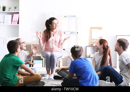 Female teacher conducting lesson at school Stock Photo