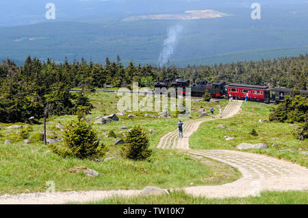 Brocken Mountain, Saxony-Anhalt / GERMANY - May 26 2019: historical locomotive is going up high to Brocken Peak with tourists. Brocken is part of Harz Stock Photo