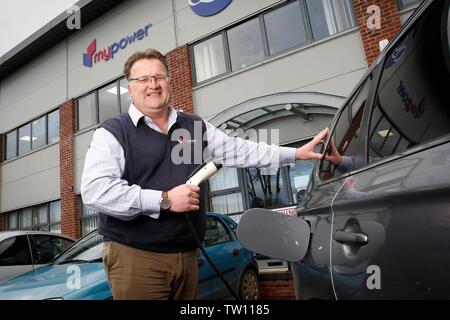 Ben Harrison, managing partner of mypower,  the solar panel installation company, who can recharge his Mitsubishi Outlander PHEV hybrid car, with elec Stock Photo