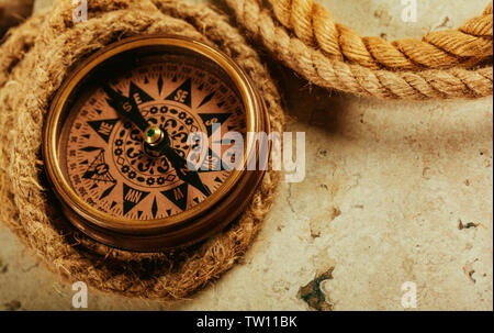 old-fashioned compass on rustic wooden table Stock Photo