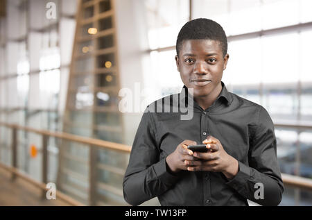Happy Afro-American Man using a Mobile Phone Stock Photo