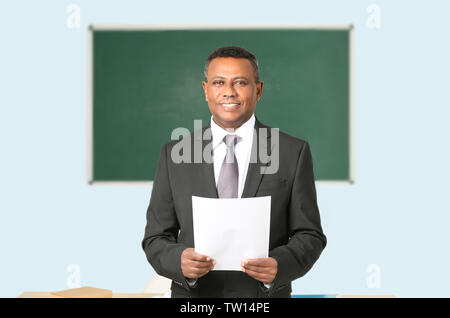 Confident Indian teacher in classroom Stock Photo