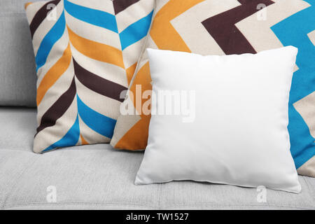 Blank soft pillow on cozy couch Stock Photo