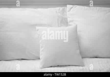 Blank soft pillows on the bed Stock Photo