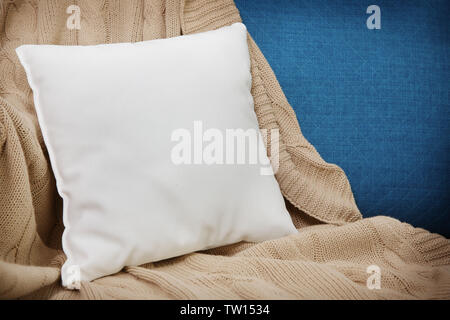 Blank soft pillow on cozy armchair Stock Photo