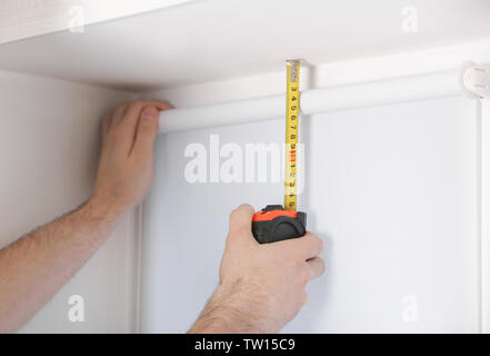 Male hands making window measurements Stock Photo