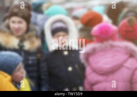 Crowd of people in warm clothes outdoors on winter day, blurred view Stock Photo