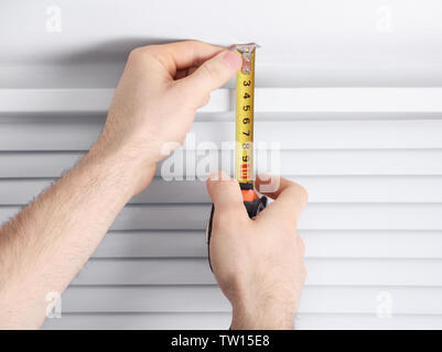 Male hands making window measurements Stock Photo