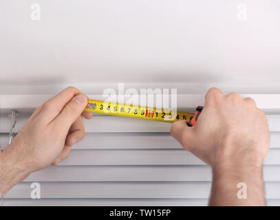 Male hands making window measurements Stock Photo