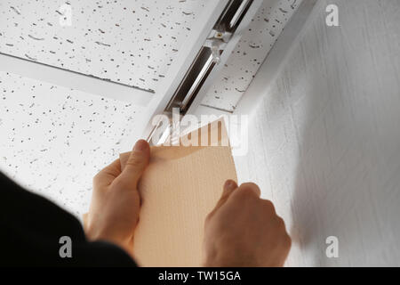 Male hands installing vertical blinds Stock Photo