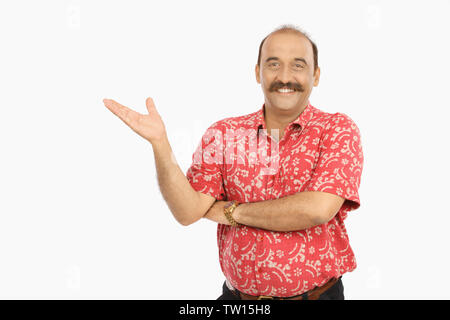 Portrait of a mature man gesturing and smiling Stock Photo