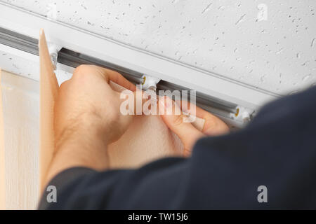 Male hands installing vertical blinds Stock Photo