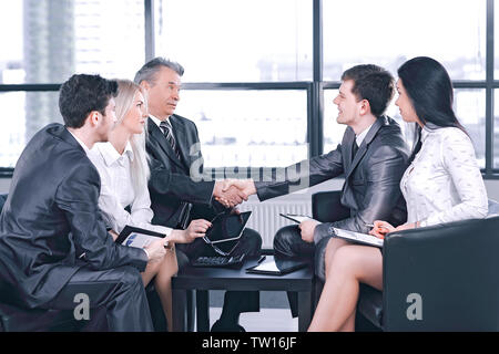 employees look at the handshake of business partners .the concept of solidarity Stock Photo