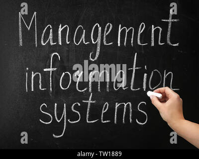 Hand writing phrase MANAGEMENT INFORMATION SYSTEMS on blackboard Stock Photo