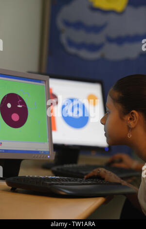 Schoolgirl using computer in a classroom Stock Photo
