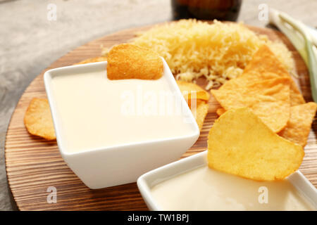 Bowls with beer cheese dip on wooden board Stock Photo