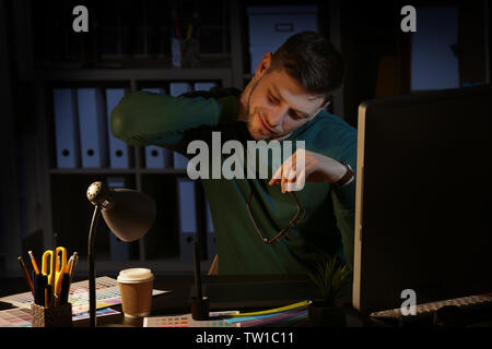 Young male designer working in office Stock Photo