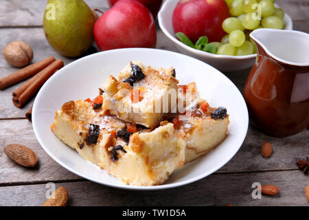 Delicious bread pudding with fruits on table Stock Photo