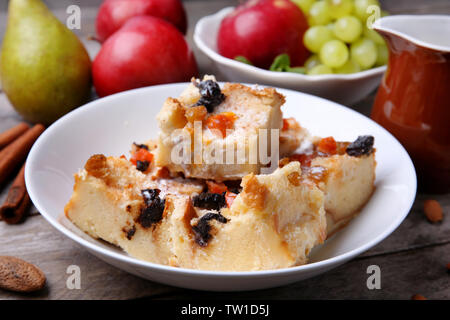 Delicious bread pudding with fruits on table Stock Photo