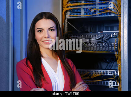 Beautiful young engineer in server room Stock Photo