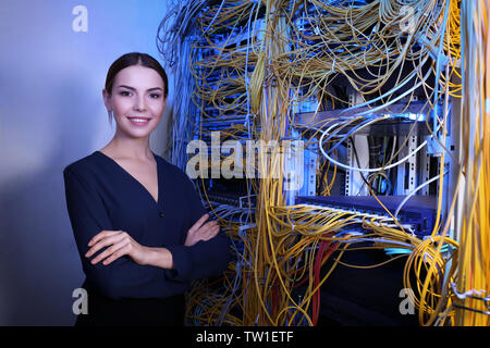 Beautiful young engineer in server room Stock Photo