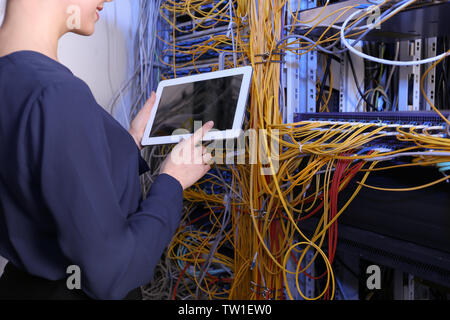 Beautiful young engineer with tablet computer in server room Stock Photo