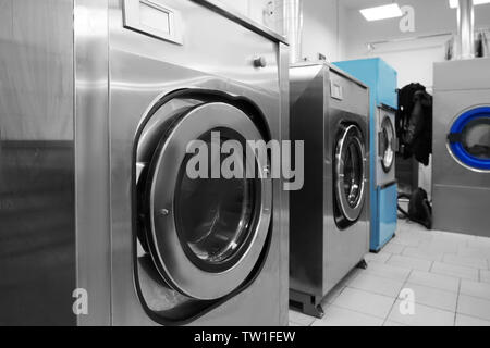 Industrial laundry washing machines in dry cleaner's workshop Stock Photo