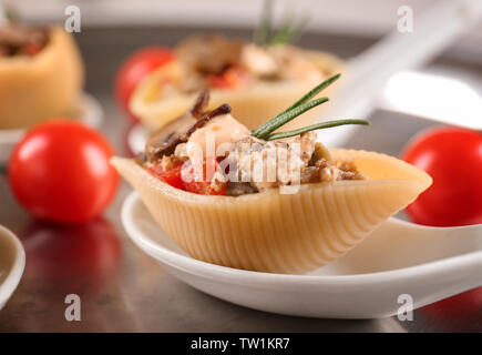 Ceramic spoon with stuffed pasta, closeup Stock Photo