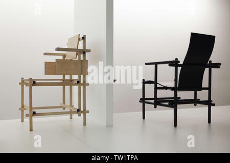 Dining Armchair (1919) and High-Backed Armchair (1924) designed by Dutch furniture designer Gerrit Rietveld on display in the Pinakothek der Moderne in Munich, Bavaria, Germany.