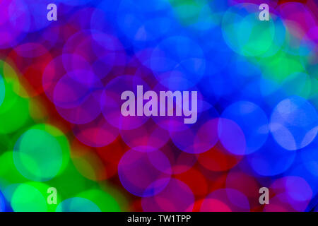 Blurry multicolored garland with glowing lights. Christmas, new year, birthday and wedding concept . Blurred background, bright colored light bulbs, l Stock Photo