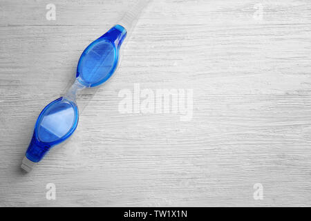 Swimming goggles on wooden background Stock Photo