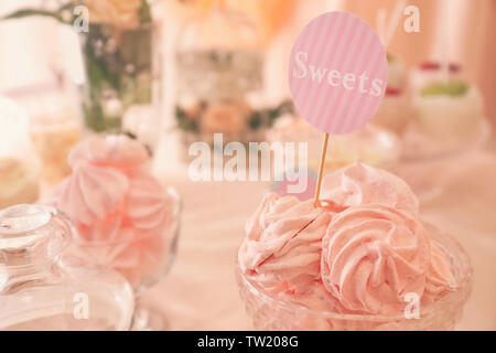 Tasty marshmallows on festive table Stock Photo