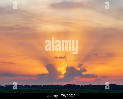 Colorful sunset with sun beams. Dramatic evening clouds Stock Photo