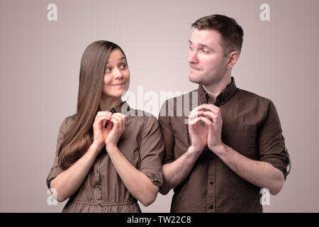 Young couple with insidious and grinning faces smile. Stock Photo