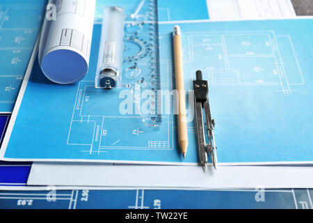 Different kinds of engineering tools on construction drawings background Stock Photo