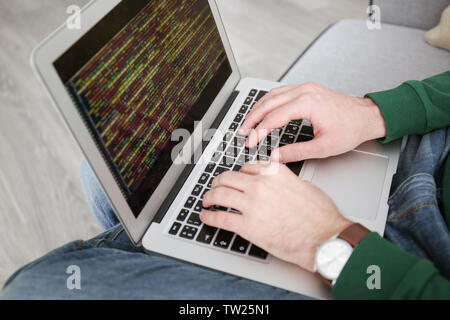 Young programmer using laptop, closeup Stock Photo