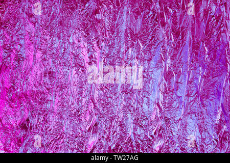 Abstract crumpled foil background. Grunge photo background. Neon colors Stock Photo