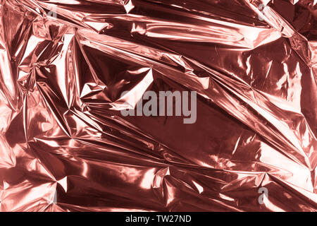Abstract crumpled foil background. Grunge photo background. Rose gold. Stock Photo