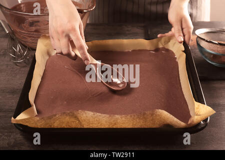Woman preparing cake in baking tray Stock Photo