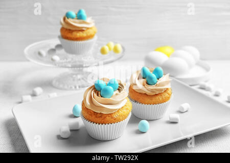 Easter cupcakes on table against grey background Stock Photo