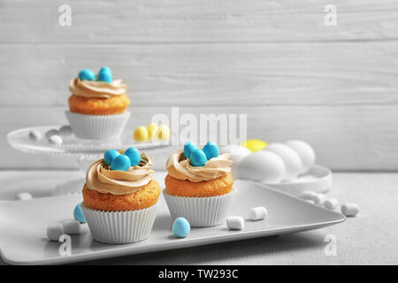 Easter cupcakes on table against grey wooden background Stock Photo