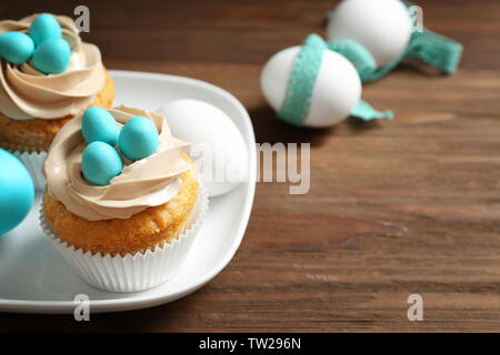 Delicious Easter cupcakes on white plate Stock Photo