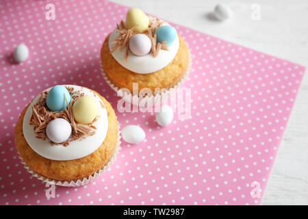 Delicious Easter cupcakes on white table Stock Photo