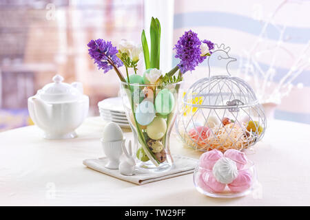 Beautiful Easter pastel decorations with table setting on blurred background Stock Photo