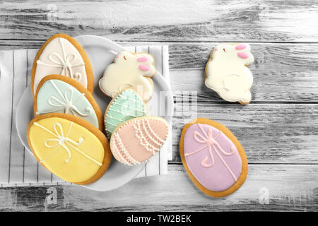 Beautiful glazed Easter cookies on wooden table Stock Photo