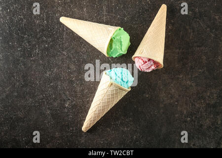 Waffle cones with colorful ice cream on table Stock Photo