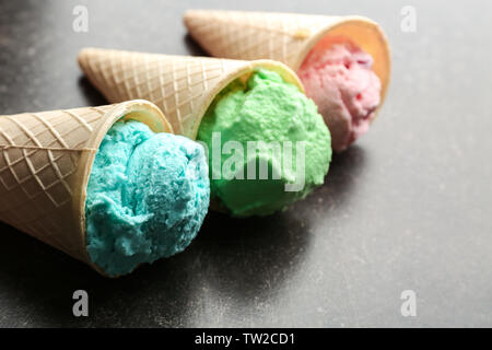 Waffle cones with colorful ice cream on table Stock Photo