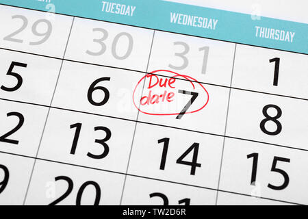 Due date written and circled in calendar, close up Stock Photo