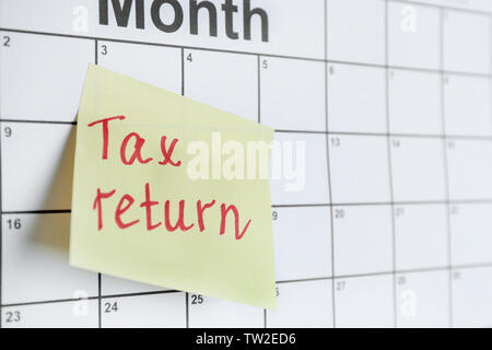 Note with text and calendar. Tax return concept Stock Photo